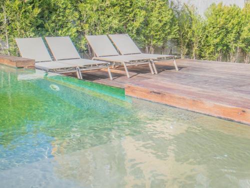 two lounge chairs sitting next to a swimming pool at PipaD'oro by YoursPorto in Porto