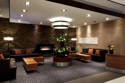 a waiting room with couches and a fireplace at Stamford Bridge Hotel London in London