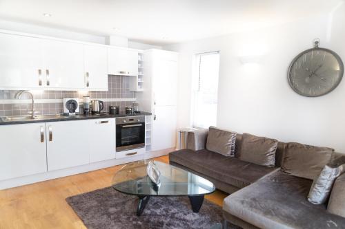 a living room with a couch and a table at Citystay Living - Marino Place in Cambridge