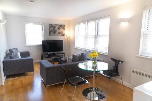 a living room with a couch and a table at Citystay Living - Marino Place in Cambridge
