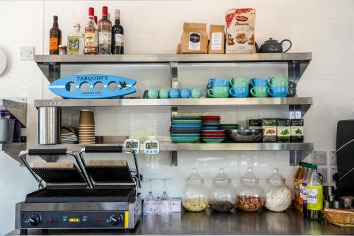 a kitchen with a refrigerator with food and drinks at Driftwood Spars in St. Agnes 