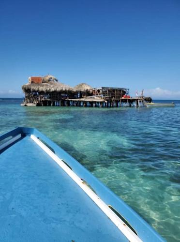 a boat in the water next to a pier at Brytan Villa in Treasure Beach