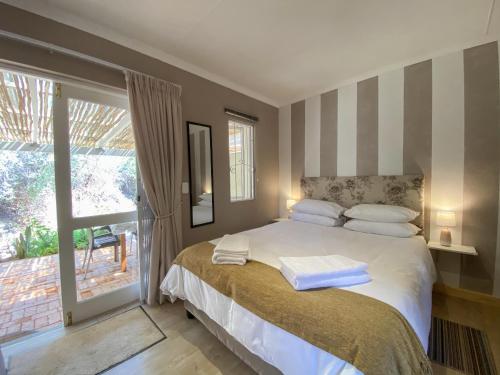 a bedroom with a bed with two towels on it at Gasteria Grange in Calitzdorp