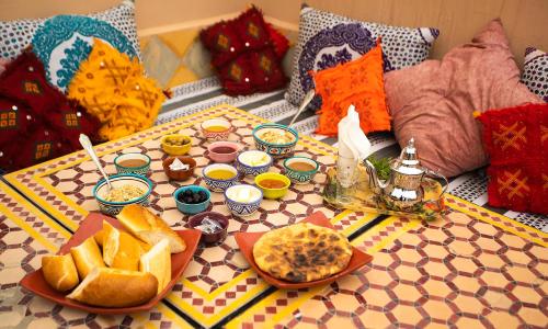 a table topped with food on top of a couch at Tigmi surf morocco in Tiguemmi nʼAït Bihi