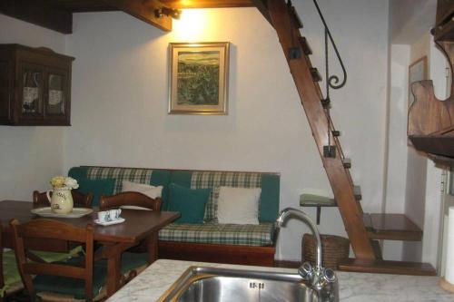a living room with a couch and a table at Dépendance Viburni in Alghero