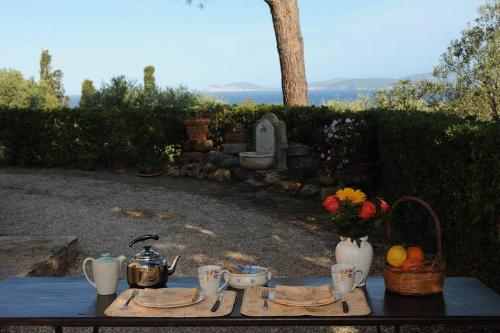 a table with food and flowers on top of it at Dépendance Viburni in Alghero