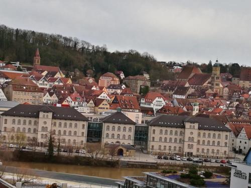 a group of buildings with a river and a city at Wohnwerk41 in Schwäbisch Hall
