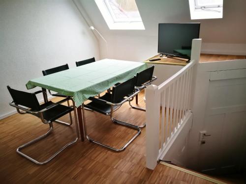 a room with a table and chairs and a television at Wohnwerk41 in Schwäbisch Hall