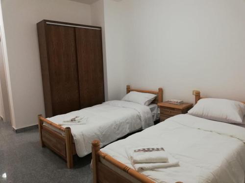 a room with two twin beds and a cabinet at Madaba Camp Resort in Madaba