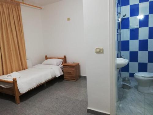 a bedroom with a bed and a sink and a toilet at Madaba Camp Resort in Madaba