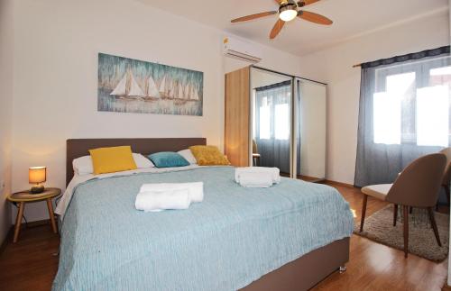 a bedroom with a blue bed with two pillows on it at Apartments Dubrovnik-Cavtat in Cavtat