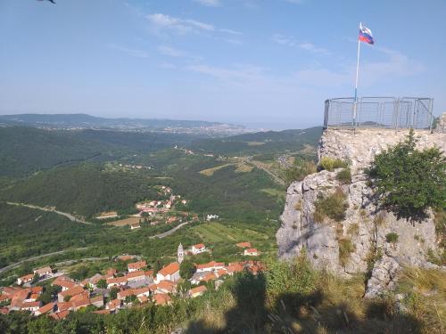 a flag on top of a mountain with a town at Relax in Črni Kal 2 in Črni Kal