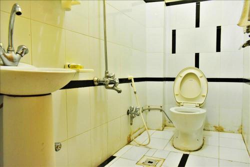 uma casa de banho com um WC e um lavatório em River Palace Hotel em Suat