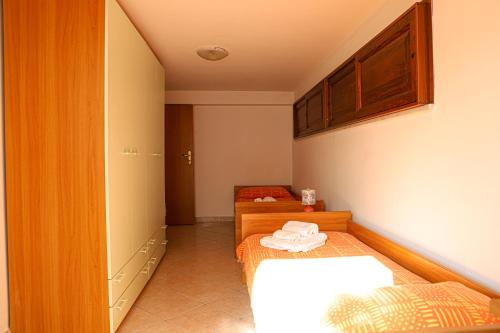 a small room with two beds and a cabinet at Oasi di Cicerone in Formia