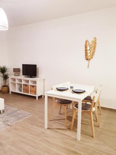 a white dining room with a white table and chairs at The Terrace House - Grémio in Olhão