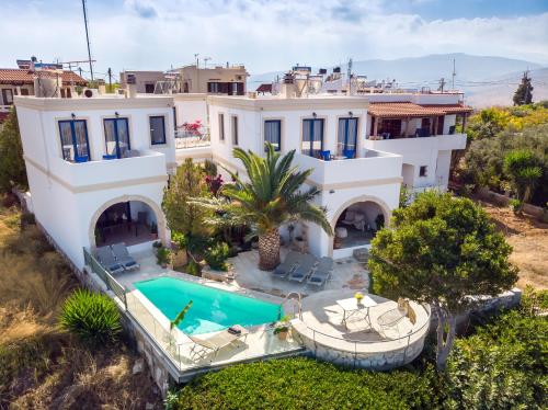 an aerial view of a house with a swimming pool at Althea Maisonettes in Áptera