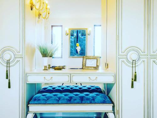 a dressing table with a blue bench in a room at Villa Shangri-La Zakinthos in Zakynthos Town