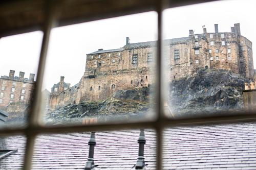 a view of a castle from a window at Grassmarket Apartment in Edinburgh