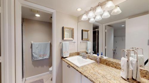 a bathroom with a sink and a mirror at Desirable Location, Directly Across Street From South Beach Access!!! in Marco Island