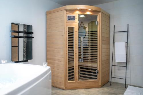 a wooden cabinet in a bathroom with a sink at Chablis SPA : duplex Grand Cru in Chablis