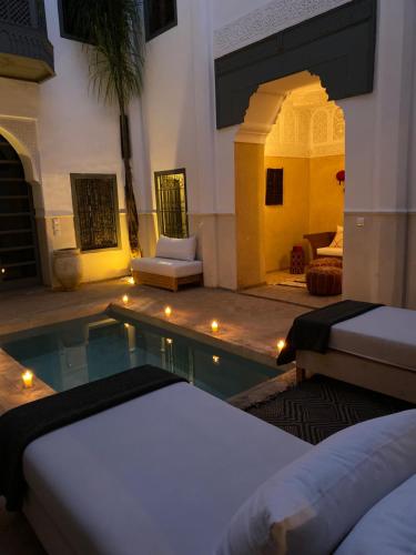 a hotel room with a swimming pool with two beds at Riad Hadika Maria in Marrakesh