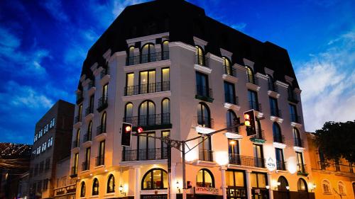 a large white building with a lot of windows at DREAM By Stannum Hotel in La Paz