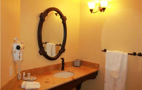 a bathroom with a sink and a mirror at Windsor Hotel & Restaurant in Del Norte