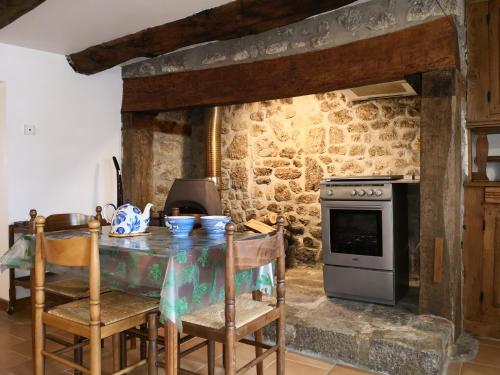 uma cozinha com uma mesa e um fogão em ESCALE NATURE em Saint-Angel