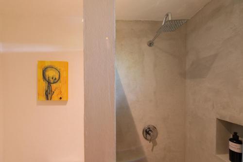 a shower in a bathroom with a painting on the wall at Art Studios in Cancún