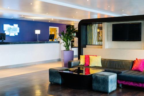 a living room with a couch and a table at Holiday Inn Express Dundee by IHG in Dundee