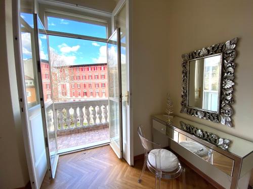 a room with a mirror and a view of a building at James Joyce Luxury Apartment in Trieste