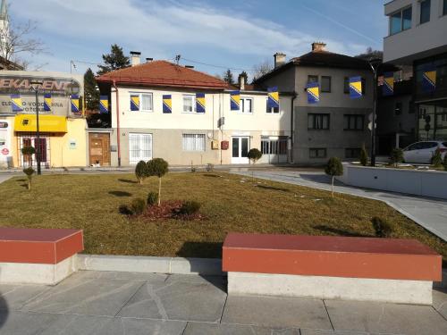 a park in front of a building with flags at Apartment New Days in Sarajevo