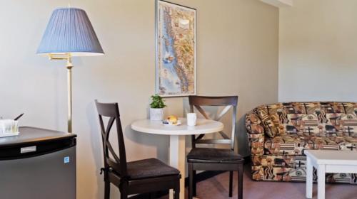 a living room with a table and a couch at Quarterdeck Inn Port Hardy in Port Hardy