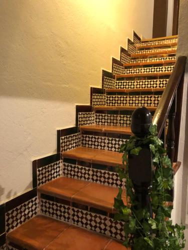 a set of stairs with a person walking up them at El Refugio de Su - Casa Rural in Auñón