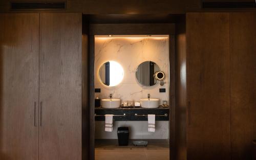 a bathroom with two sinks and a mirror at The Fives Oceanfront in Puerto Morelos