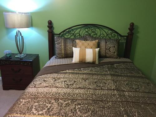 a bedroom with a large bed with a wooden headboard at Your Midwest Dunes Vacation Tri-State Paradise! in Chesterton