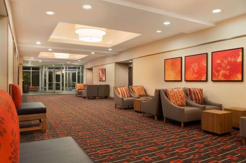 a waiting room at a hospital with chairs and tables at Hyatt Place Houston/The Woodlands in The Woodlands