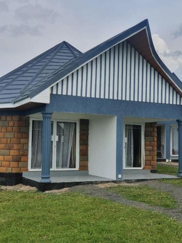 a house with a metal roof on top of it at VICTORIA SANDS LODGE in Mbita