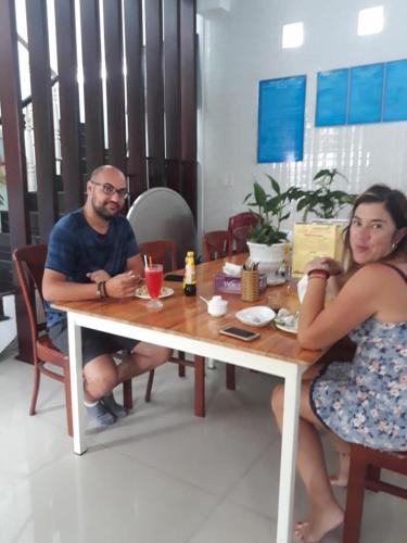 a man and a woman sitting at a table at Quynh Long Villa in Hoi An