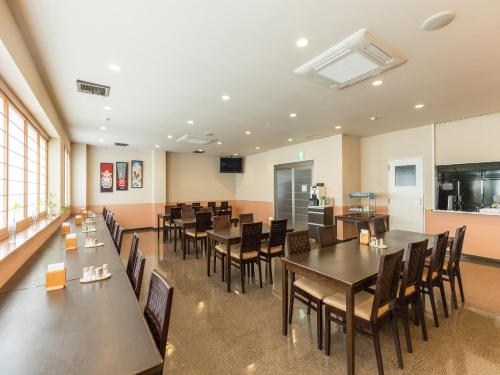 a large dining room with tables and chairs at Hotel Isesaki East in Isesaki