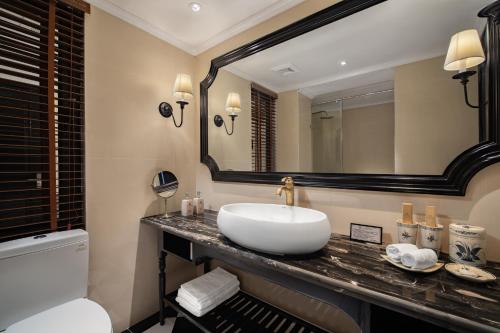 a bathroom with a sink and a mirror at My Gallery Boutique Hotel & Spa in Sa Pa