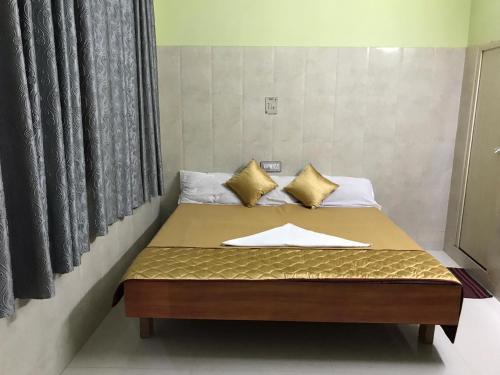 a bed in a room with at Rehoboth Home Stay in Kanyakumari