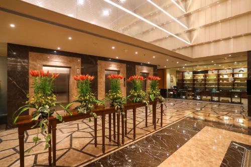 a row of flowers in a hotel lobby at Radisson Blu Hotel Chennai City Centre in Chennai