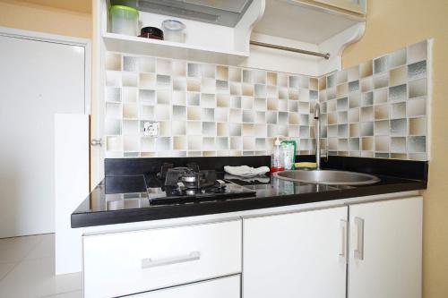 a kitchen with a sink and a counter top at Vika Property GPC in Jakarta