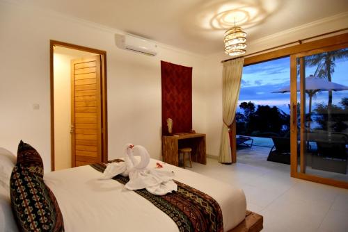 Llit o llits en una habitació de Bali Mimpi luxurious villa with great ocean views!