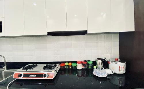 a kitchen counter with a stove and some bottles at HOTEL ĐỨC THÀNH 2 in Con Dao