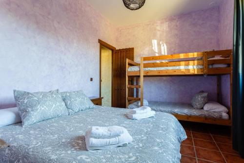 a bedroom with a bed with two bunk beds at El Castillito in Chiclana de la Frontera