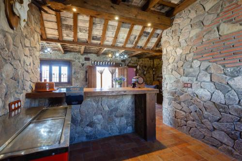 a bar in a stone building with a stone wall at El Castillito in Chiclana de la Frontera