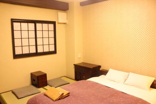 Ένα ή περισσότερα κρεβάτια σε δωμάτιο στο K's House Tokyo Oasis - Quality Hostel in Asakusa