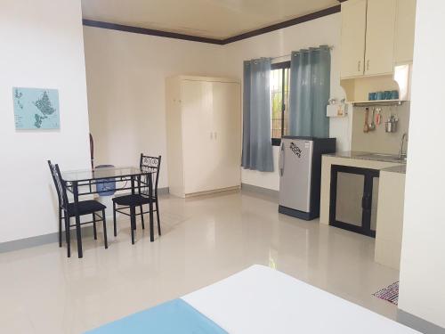 a kitchen and dining room with a table and chairs at Yayay Siargao in General Luna